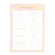 On a white background is a pink and tan designed shopping list notepad with lines underneath each food group header and text at the top that reads, "shopping list.".