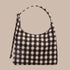 A brown and black blurred gingham print shoulder bag. 
