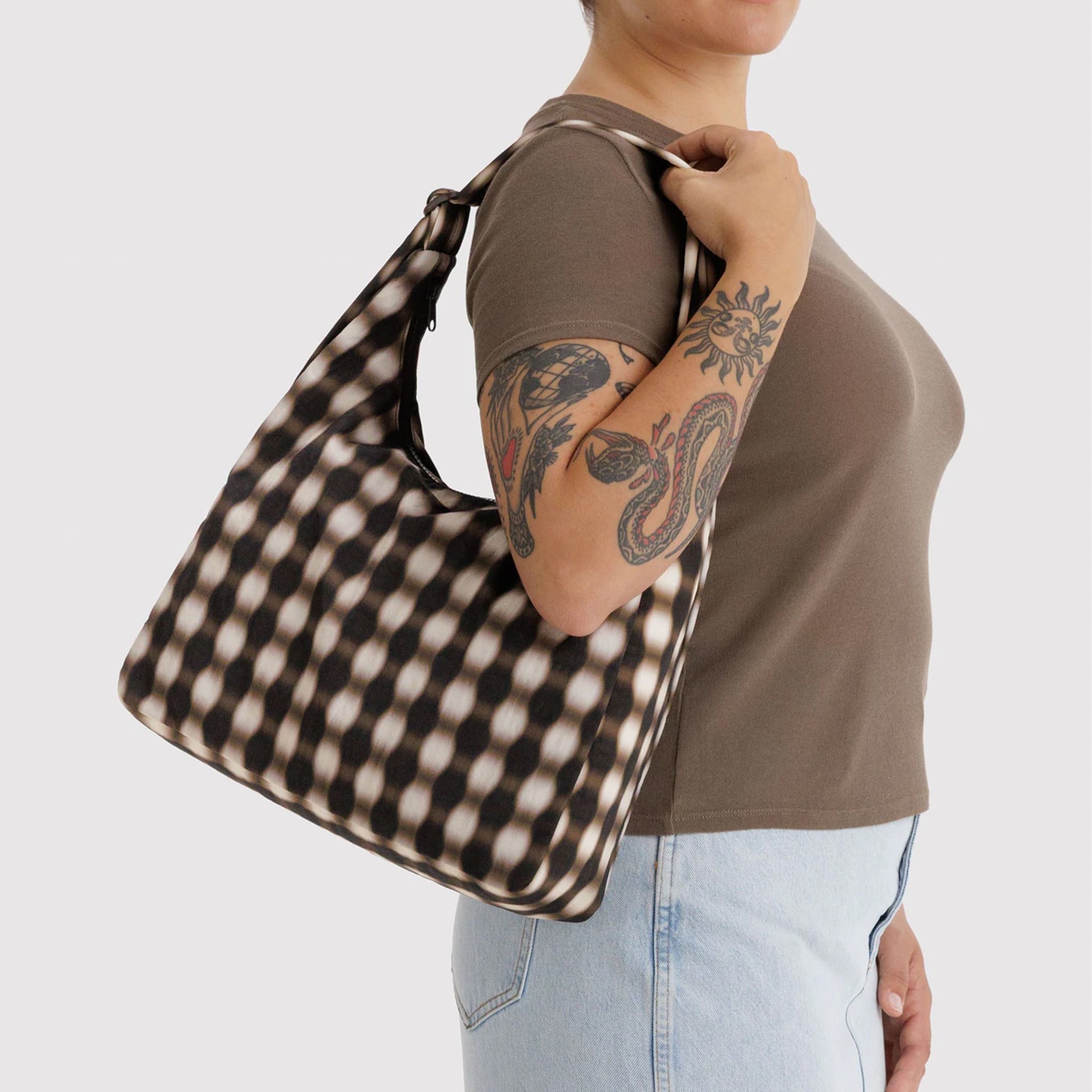 A brown and black blurred gingham print shoulder bag. 