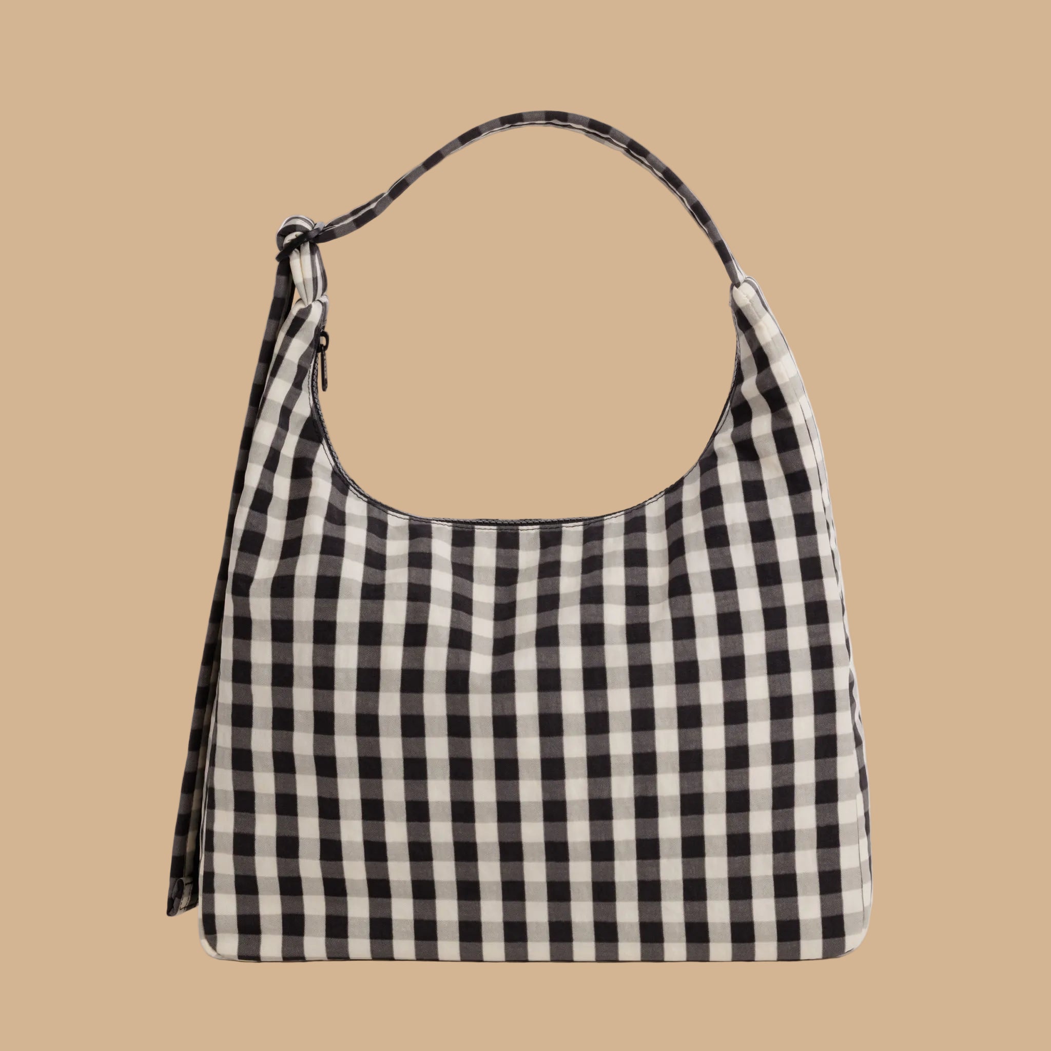 A black and cream gingham shoulder bag.