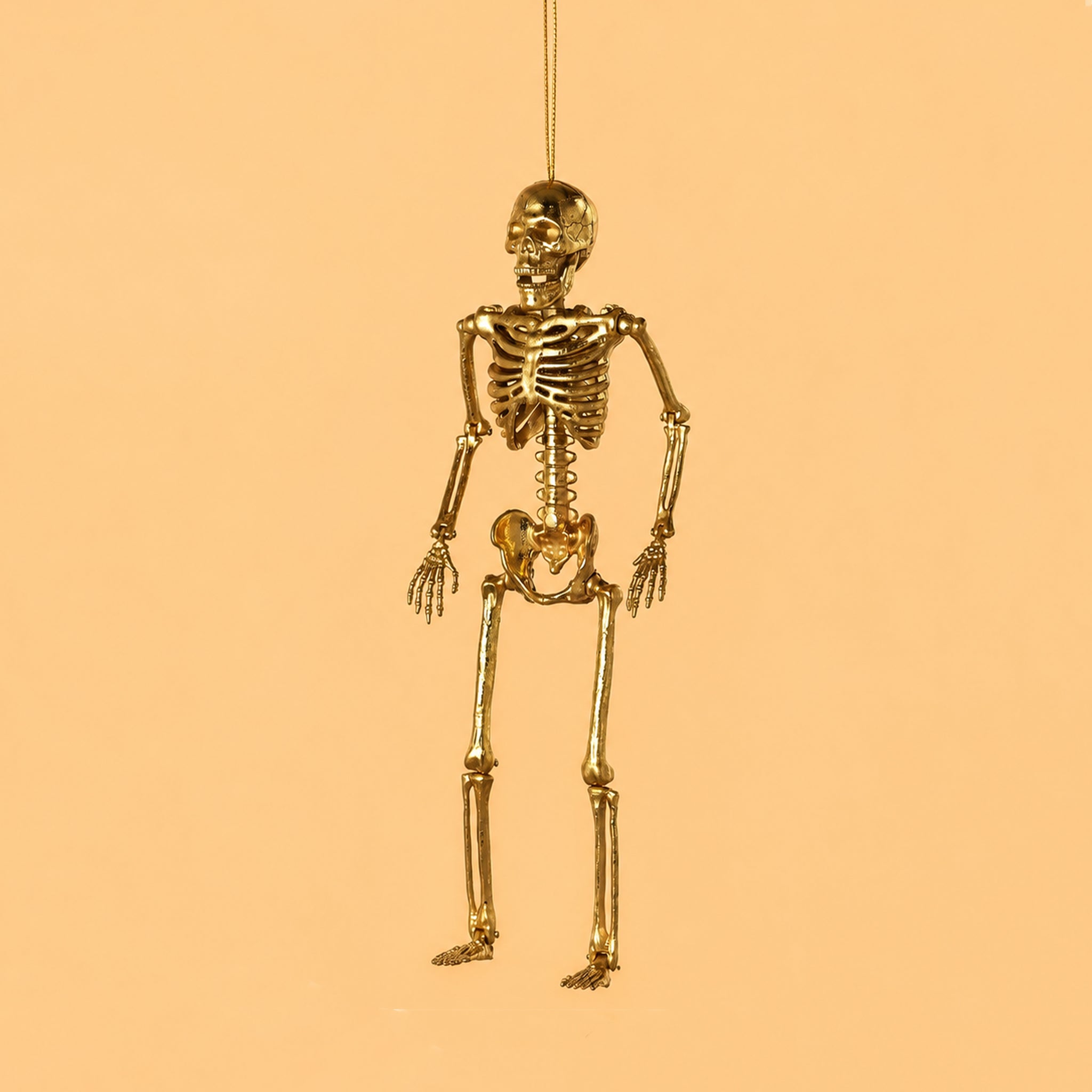 A gold skeleton shaped ornament. 