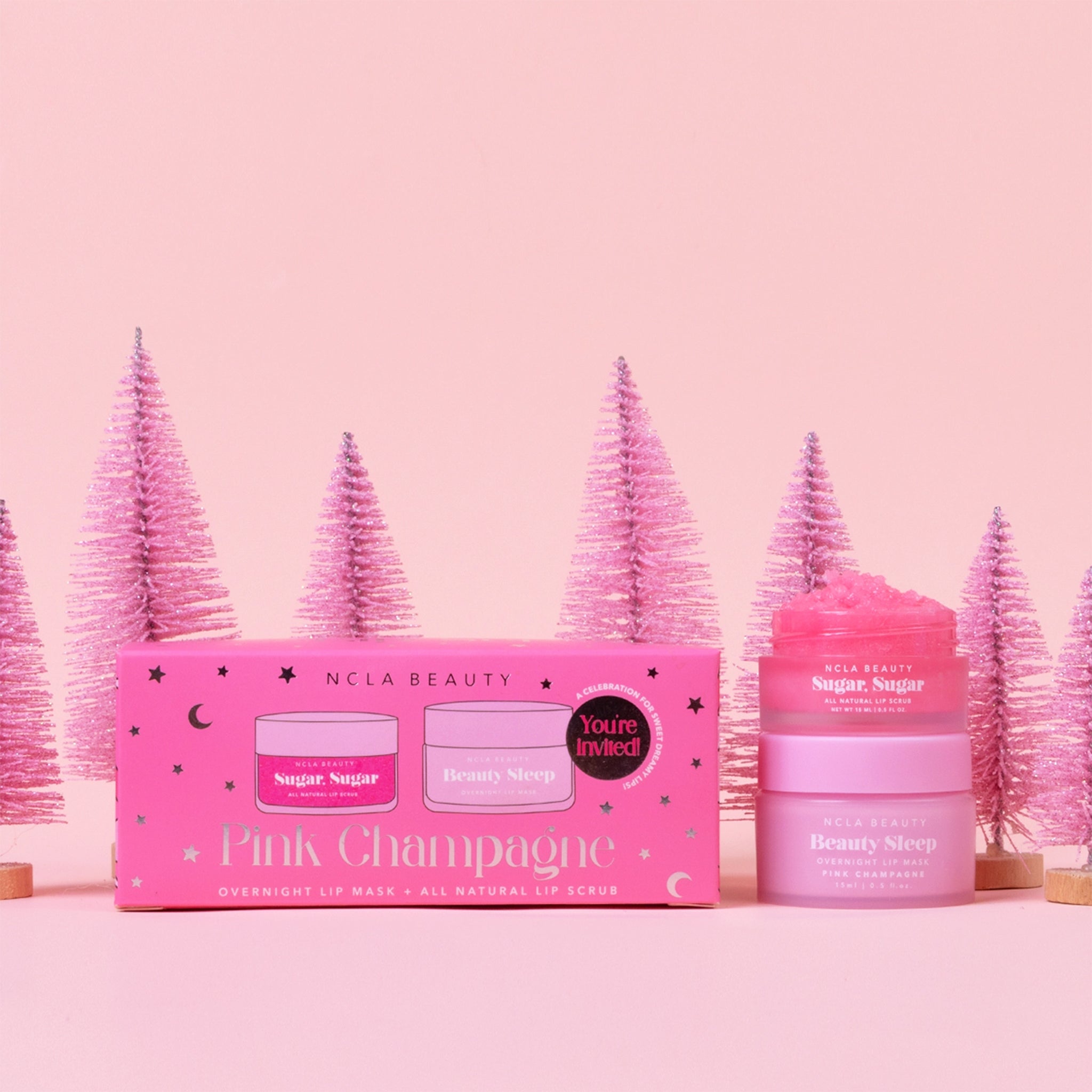 A pink box filled with a lip scrub and lip mask in a pink champagne scent. 