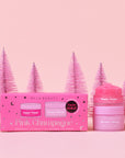 A pink box filled with a lip scrub and lip mask in a pink champagne scent. 