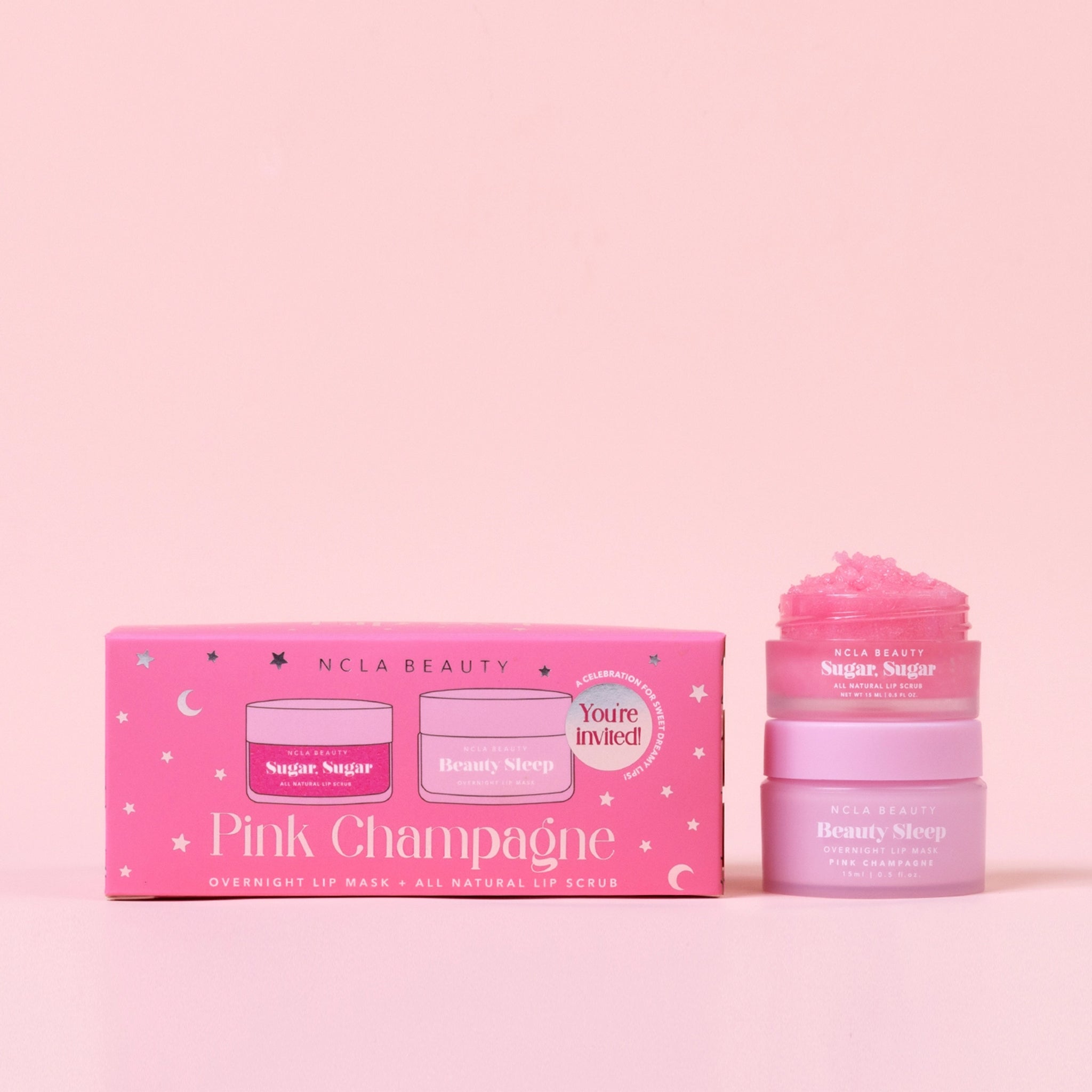 A pink box filled with a lip scrub and lip mask in a pink champagne scent. 