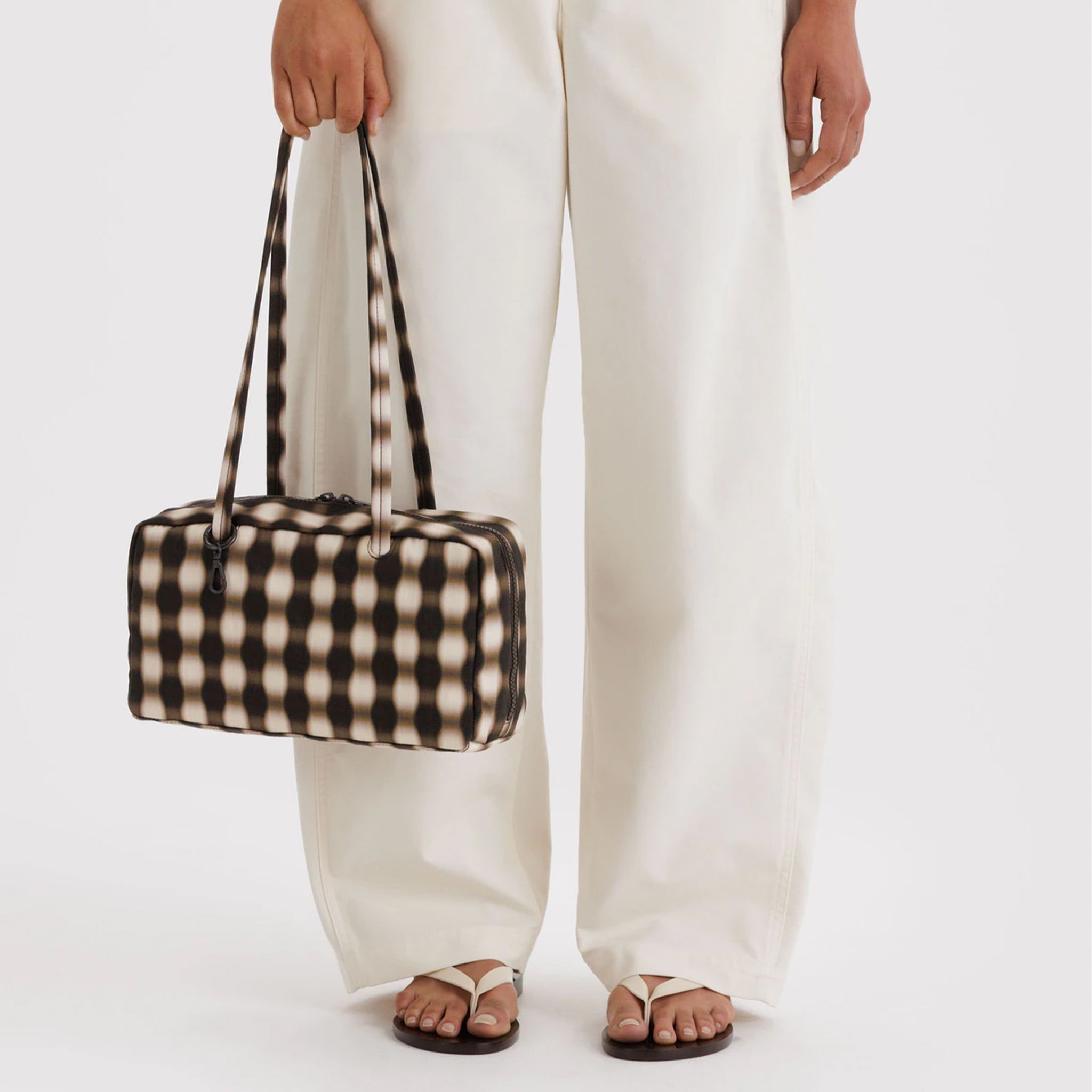 A brown and tan blurred gingham print rectangle handbag. 