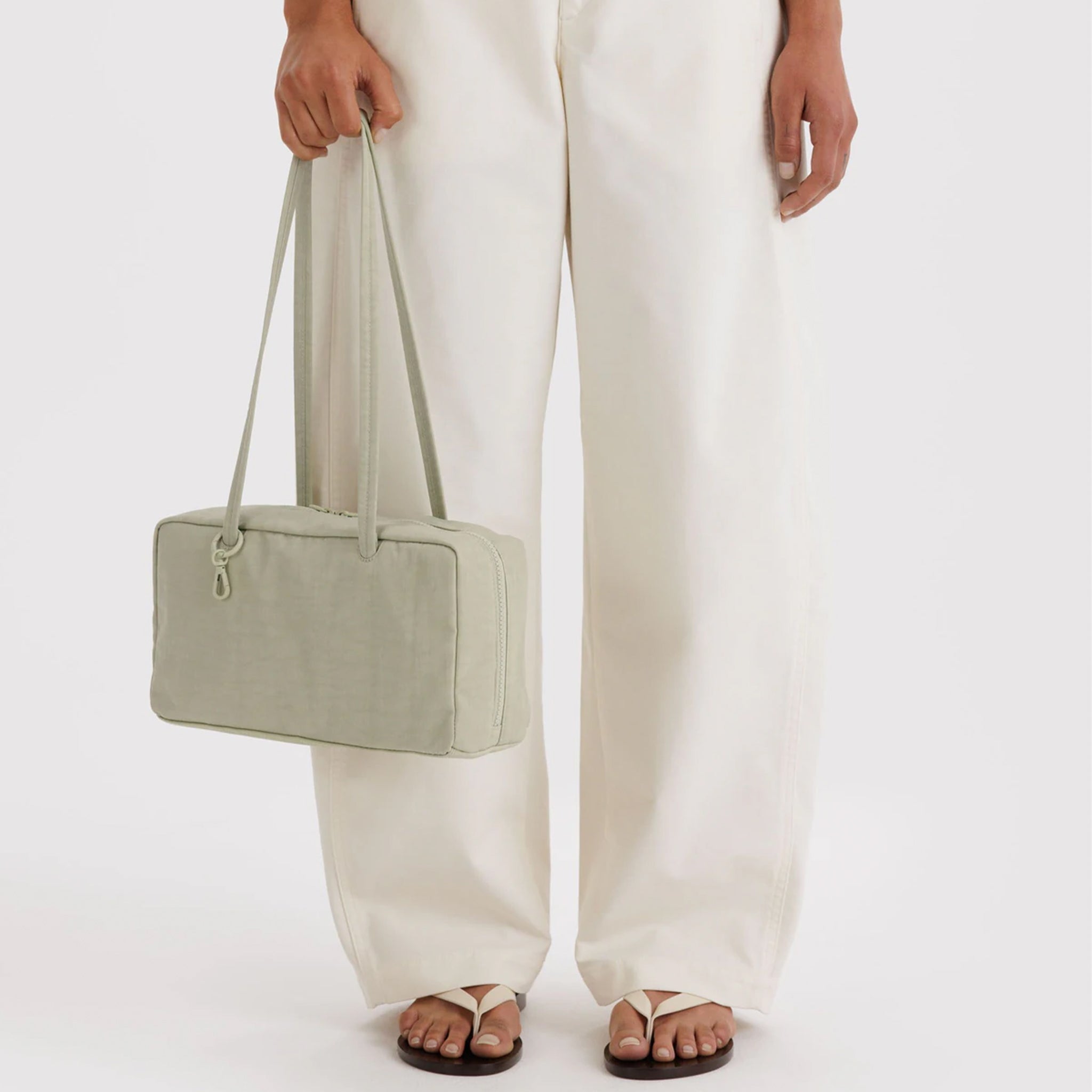 A super pale green nylon rectangle shaped shoulder bag. 
