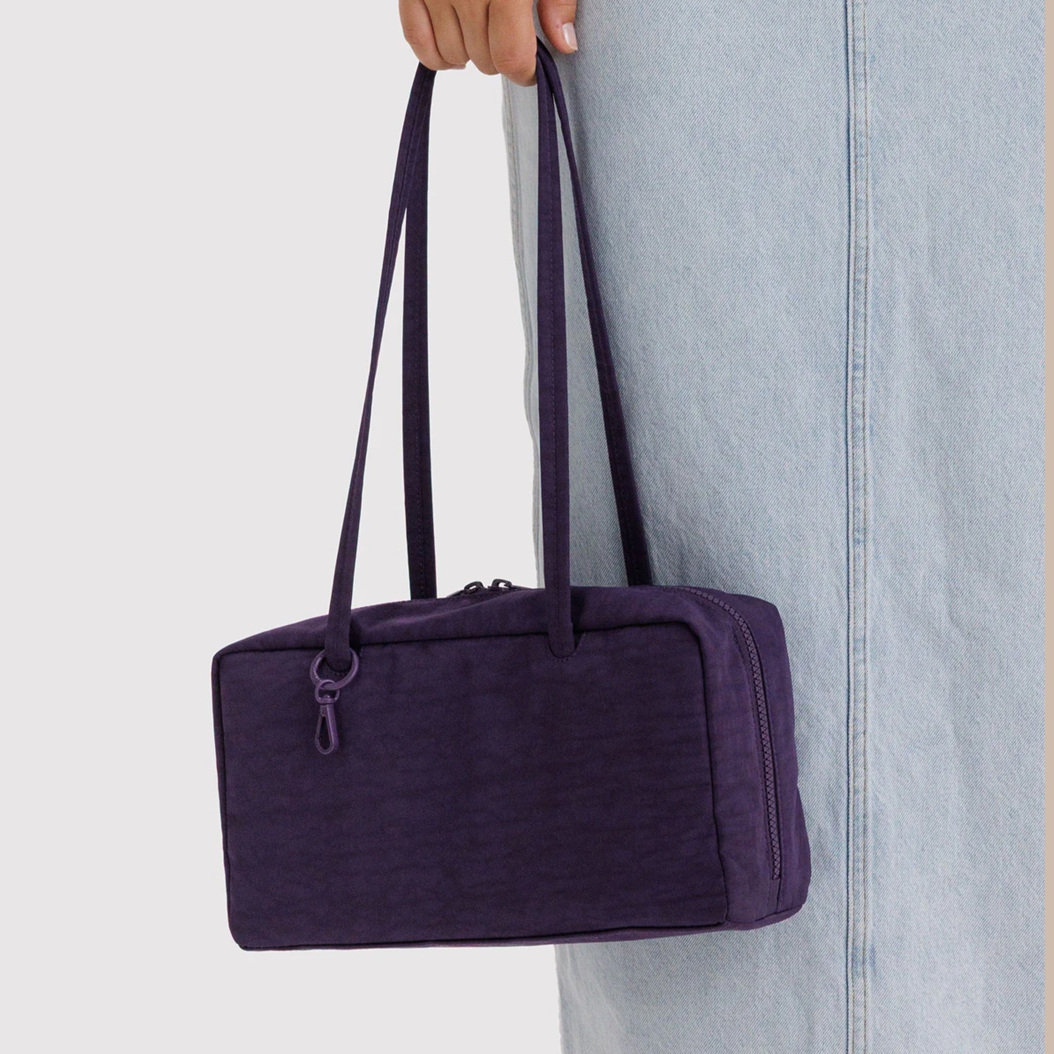 A dark purple nylon shoulder bag. 