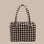 A brown and tan blurred gingham print carry on tote bag. 