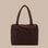 A dark brown nylon carry on tote bag. 