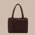 A dark brown nylon carry on tote bag. 