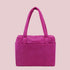 A hot pink nylon carry on tote bag. 
