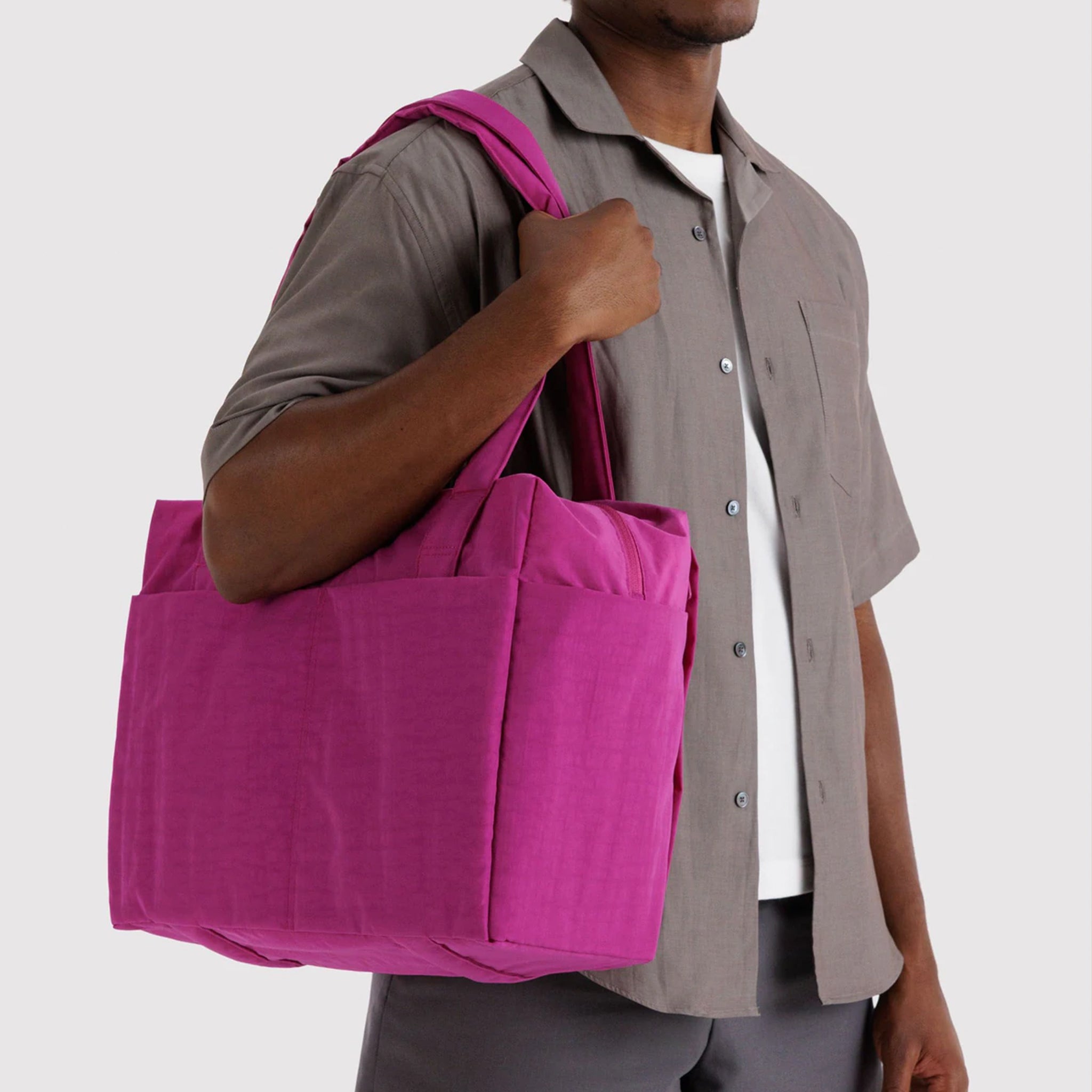 A hot pink nylon carry on tote bag. 