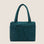 A dark teal colored carry on tote bag. 