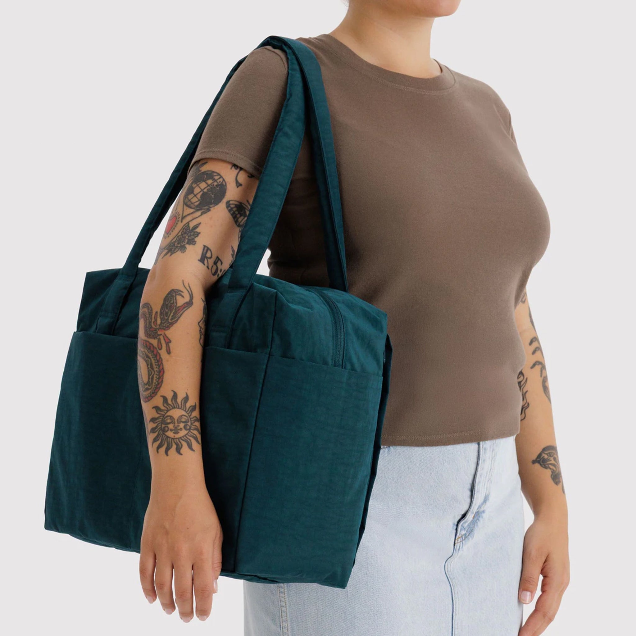 A dark teal colored carry on tote bag. 