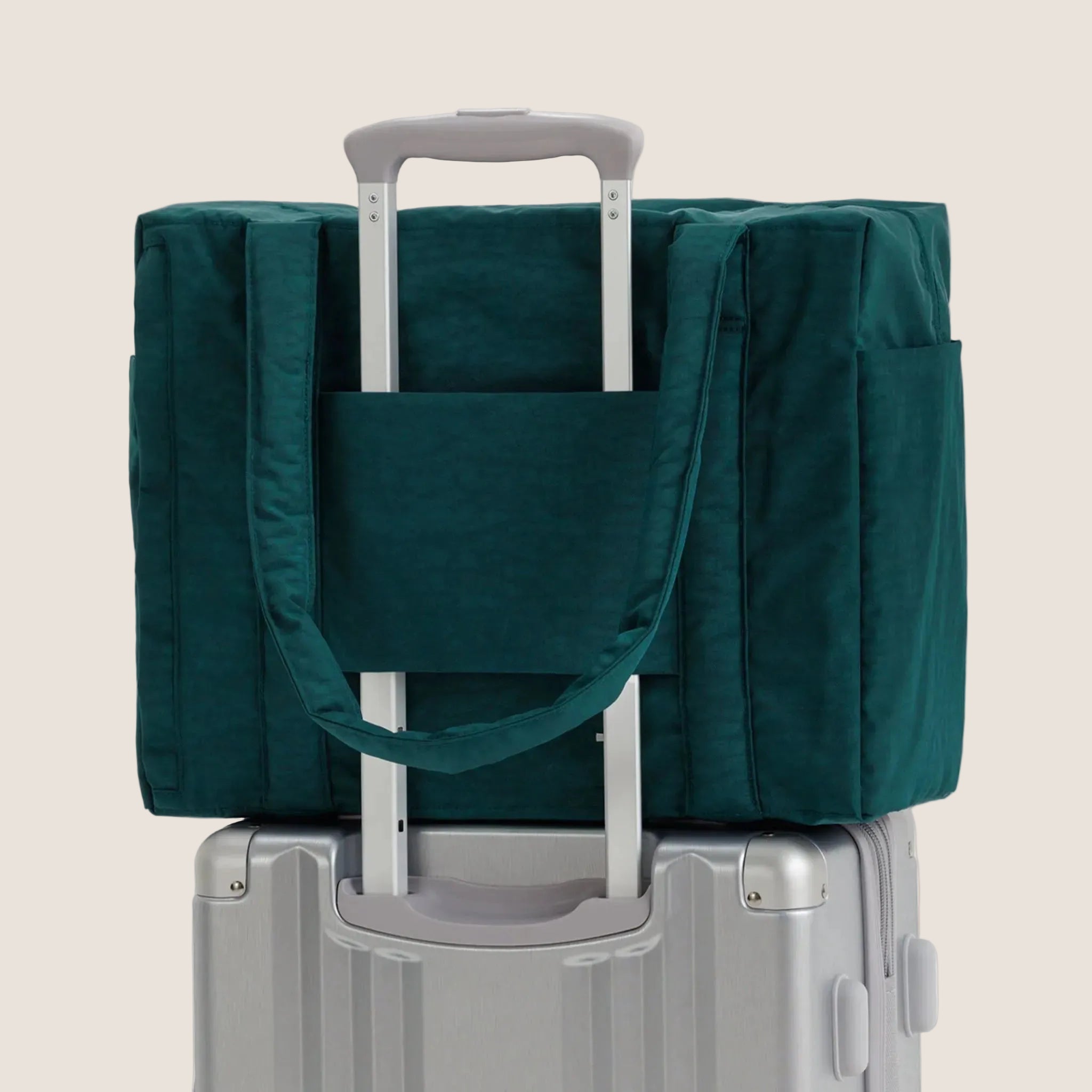 A dark teal colored carry on tote bag. 