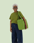 A green puffer carry on tote bag. 