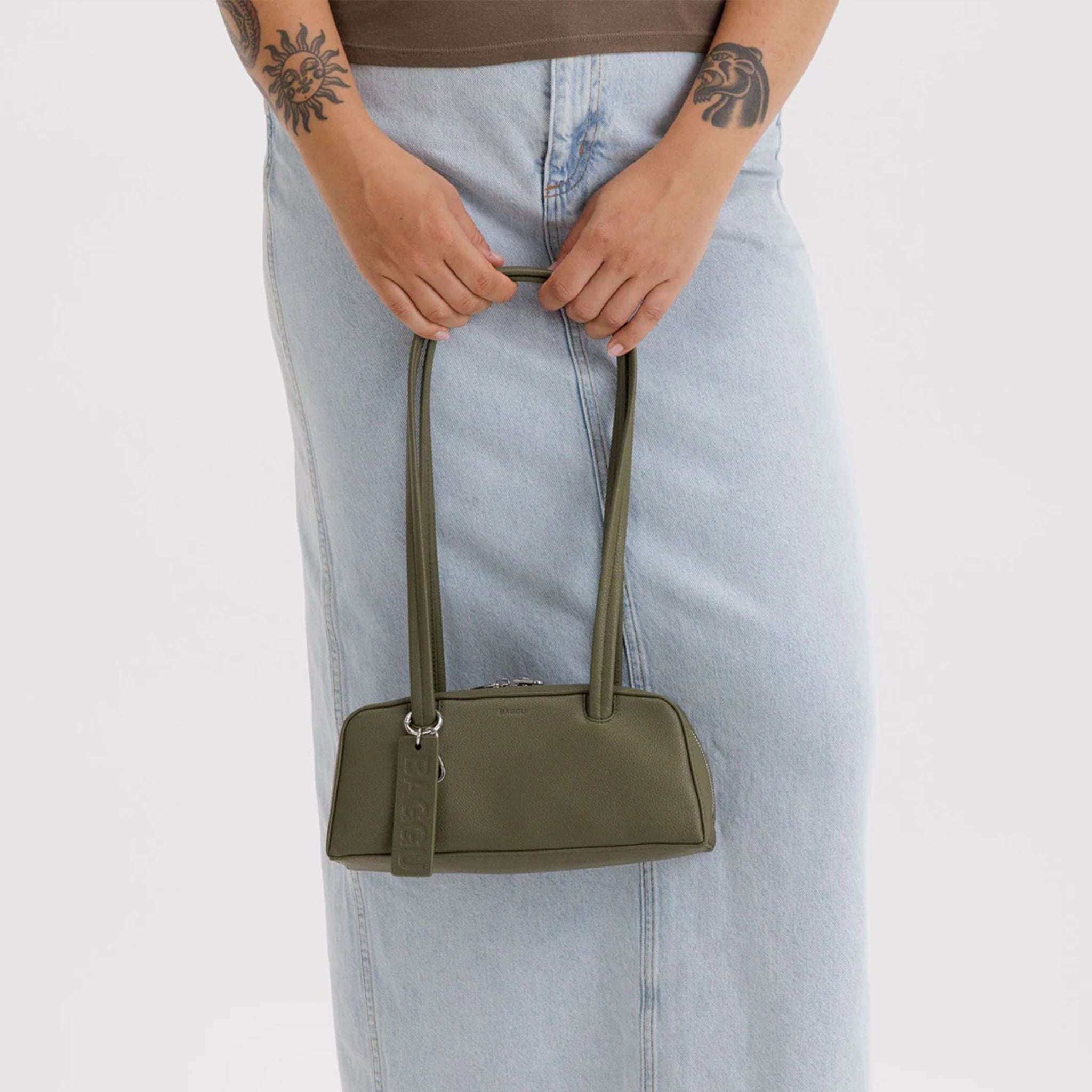 A green recycled leather shoulder bag. 