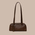 A small recycled brown leather handbag with shoulder straps. 