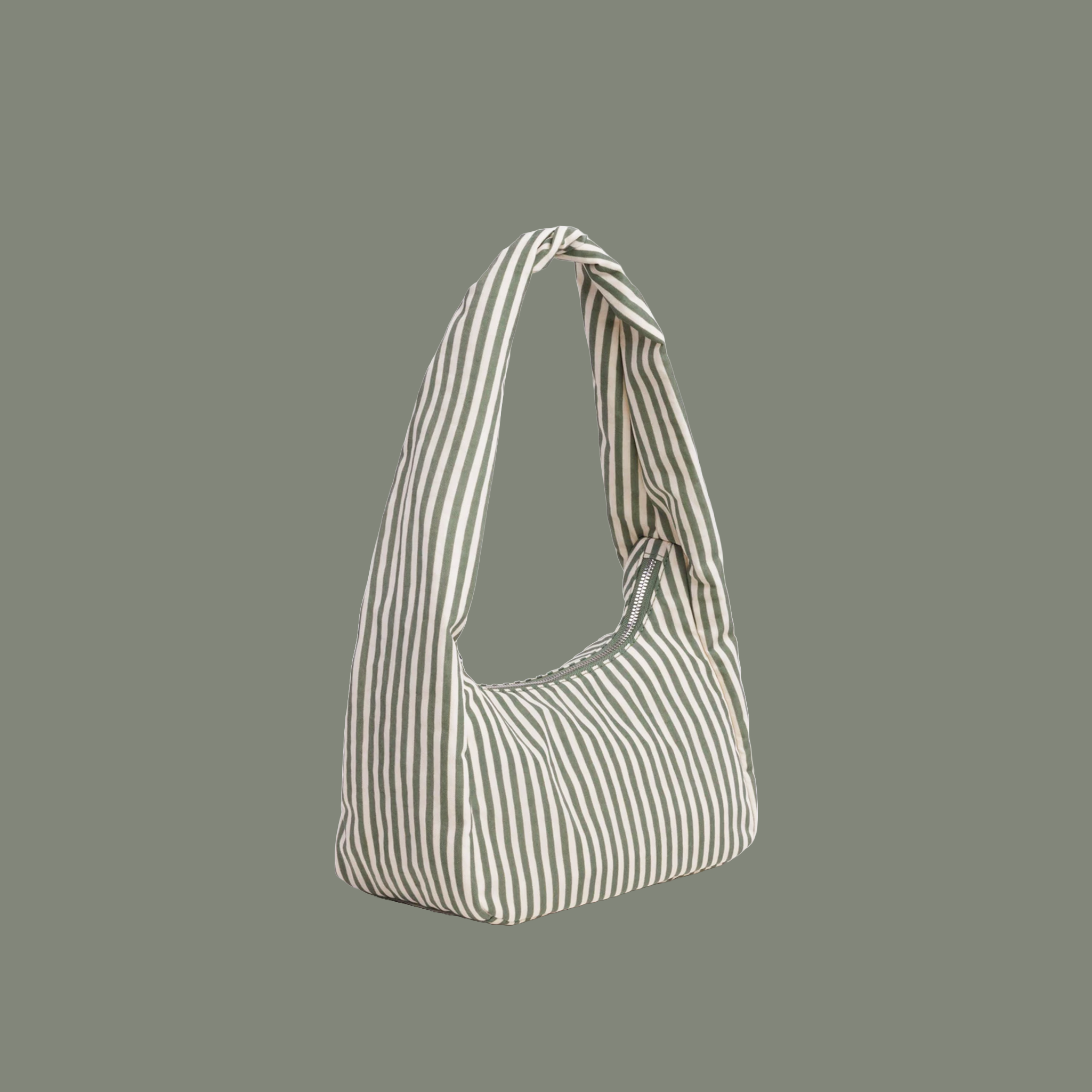small striped bag with sage colored stripes on a sage colored background.