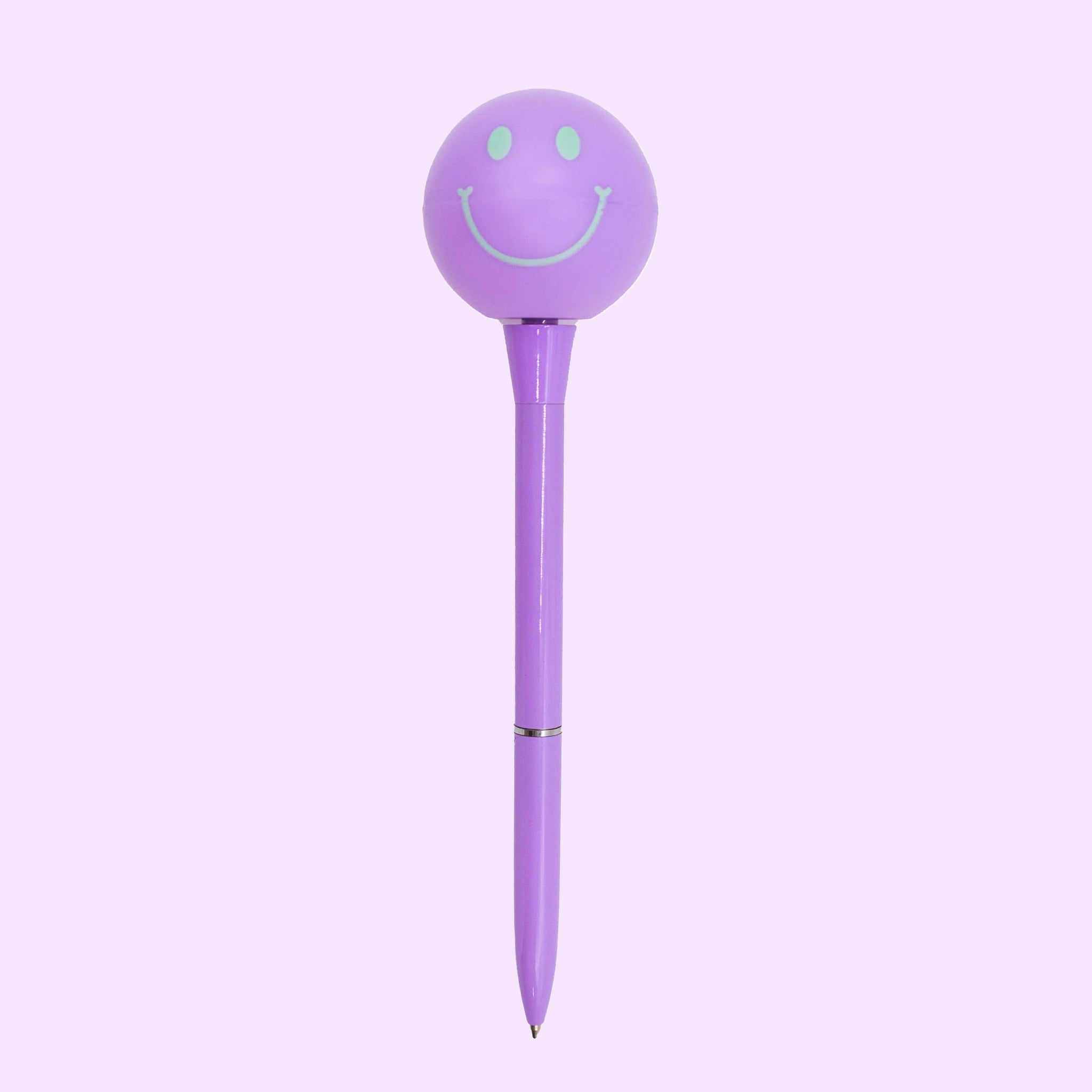 On a purple background is a purple pen with a circle spinning smiley face at the top. 