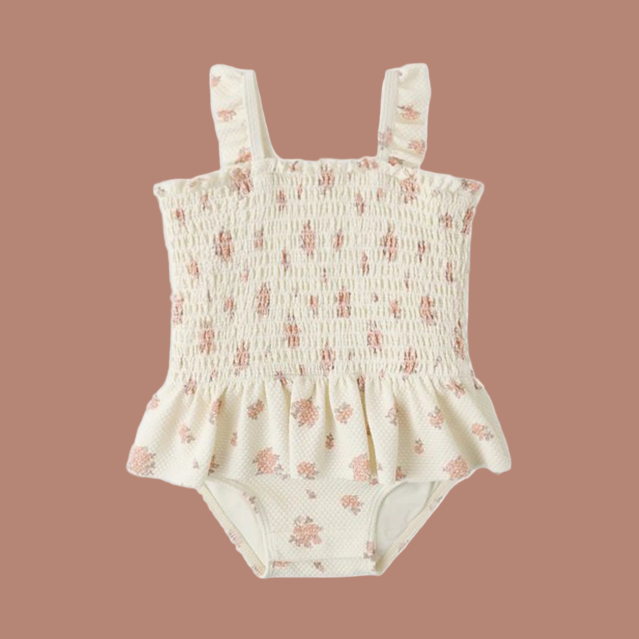 A cream colored smocked one pice swimsuit with a garden rose pattern. 