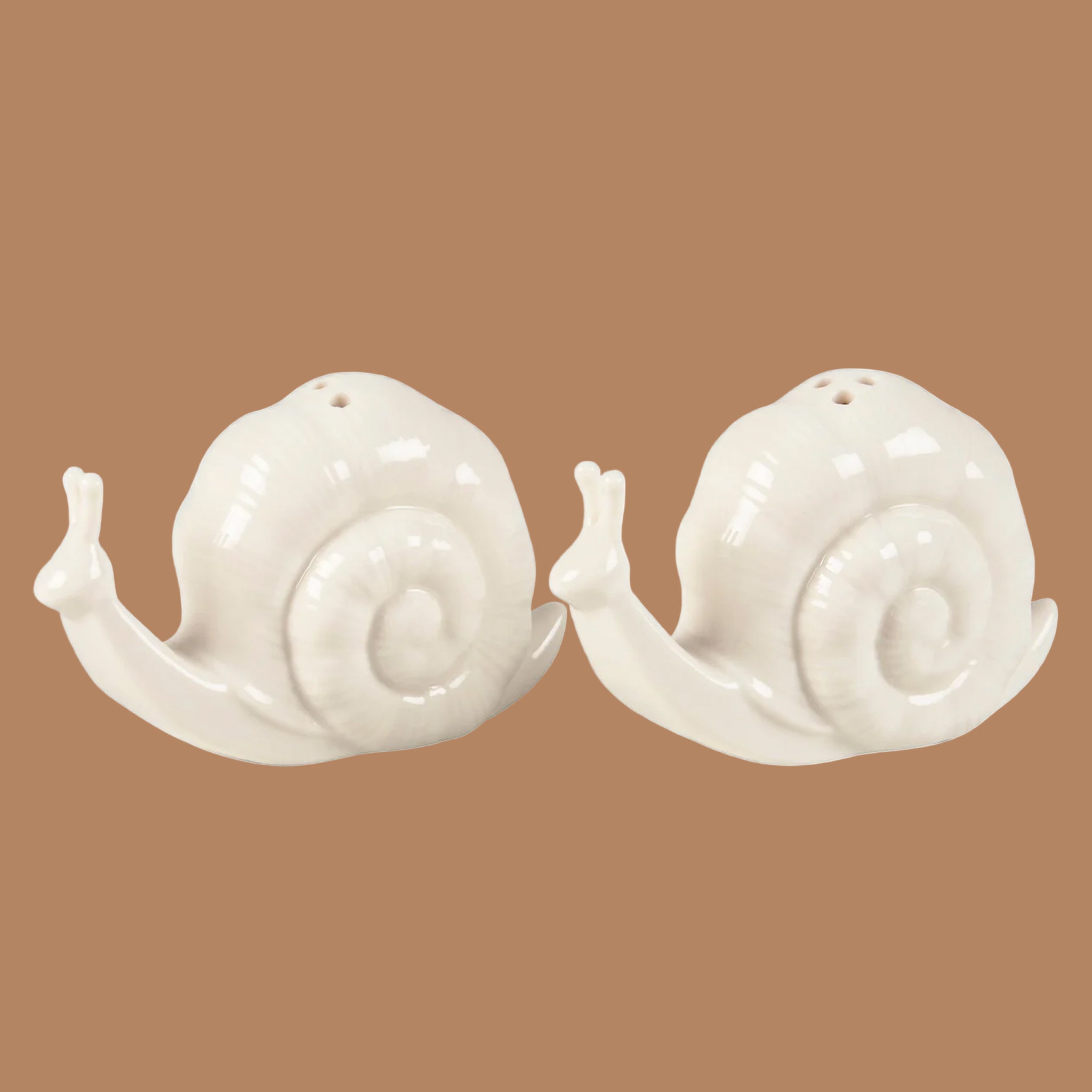 A white set of snail shaped salt and pepper shakers. 
