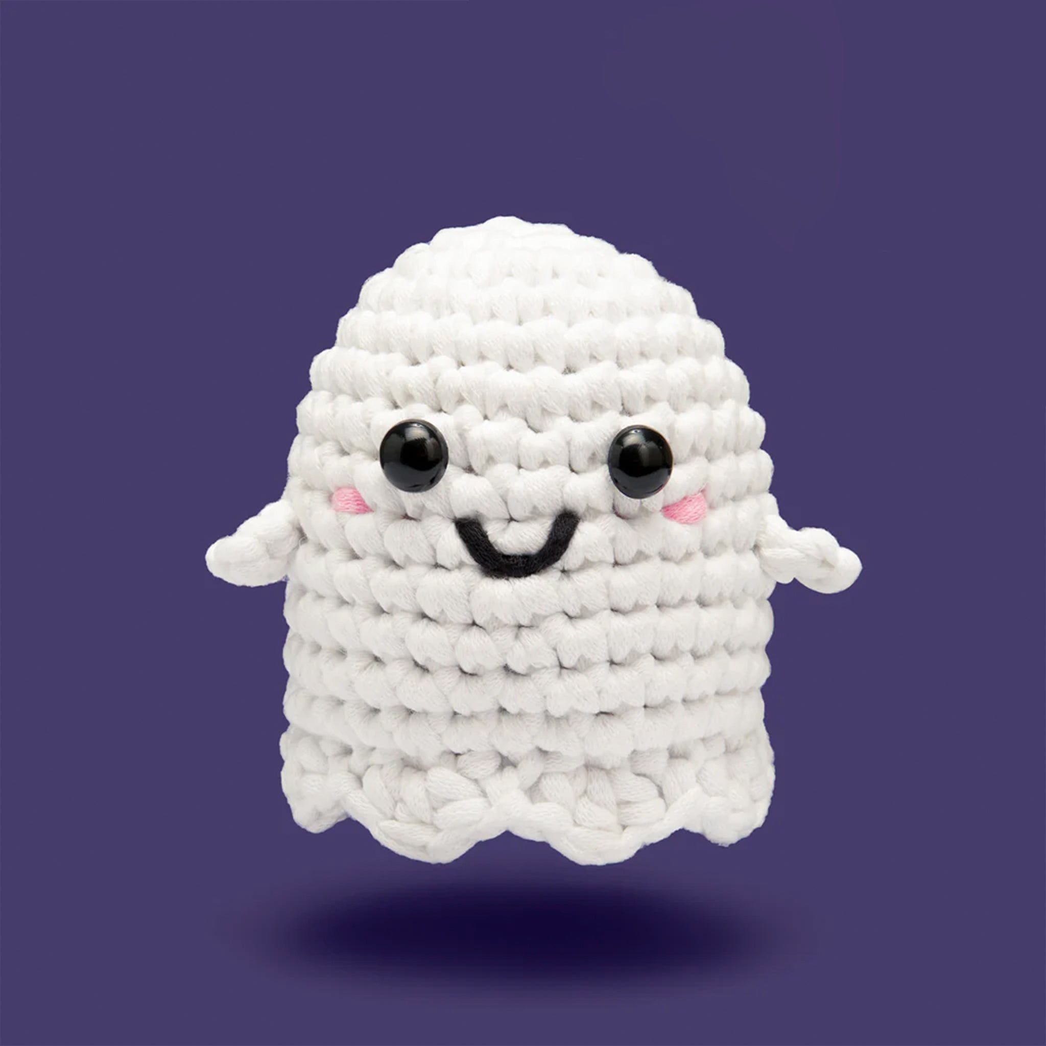 A crochet kit that makes a white ghost with a smiling face. 