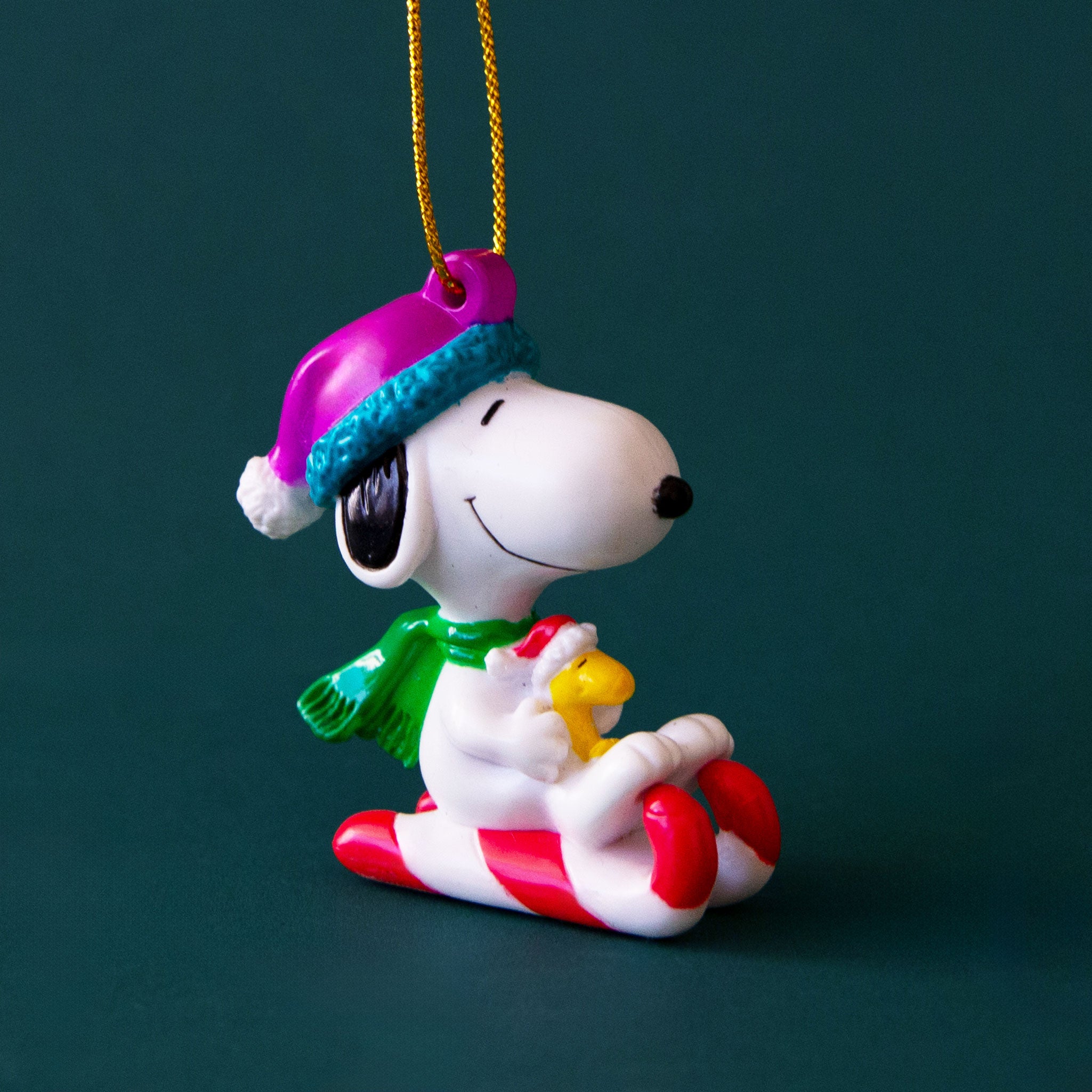 A vintage Snoopy ornament with him and Woodstock on a candy cane sled. 