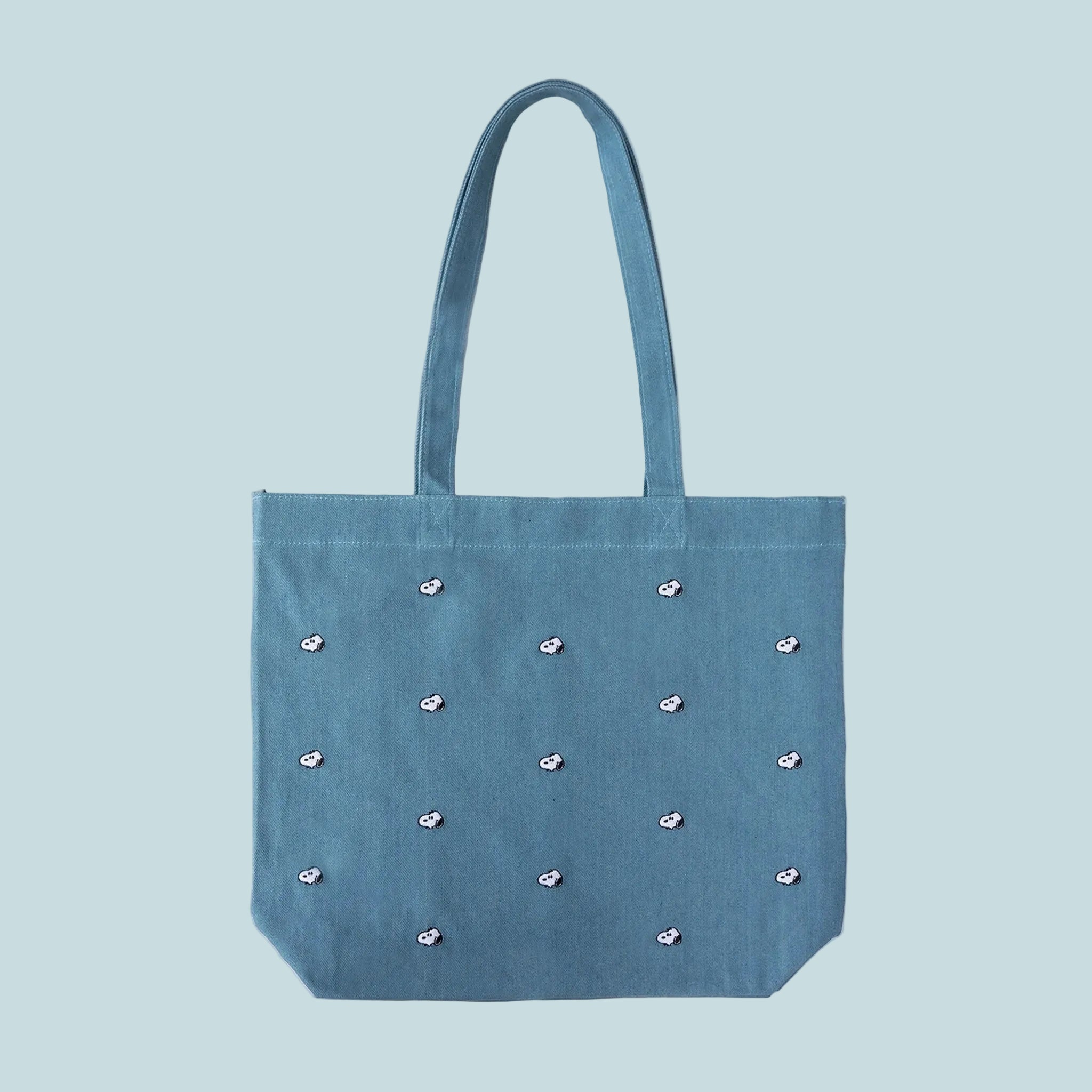 blue denim tote bag with a Snoopy embroidered pattern. 