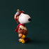 A snoopy shaped ornament wearing a pilot outfit. 