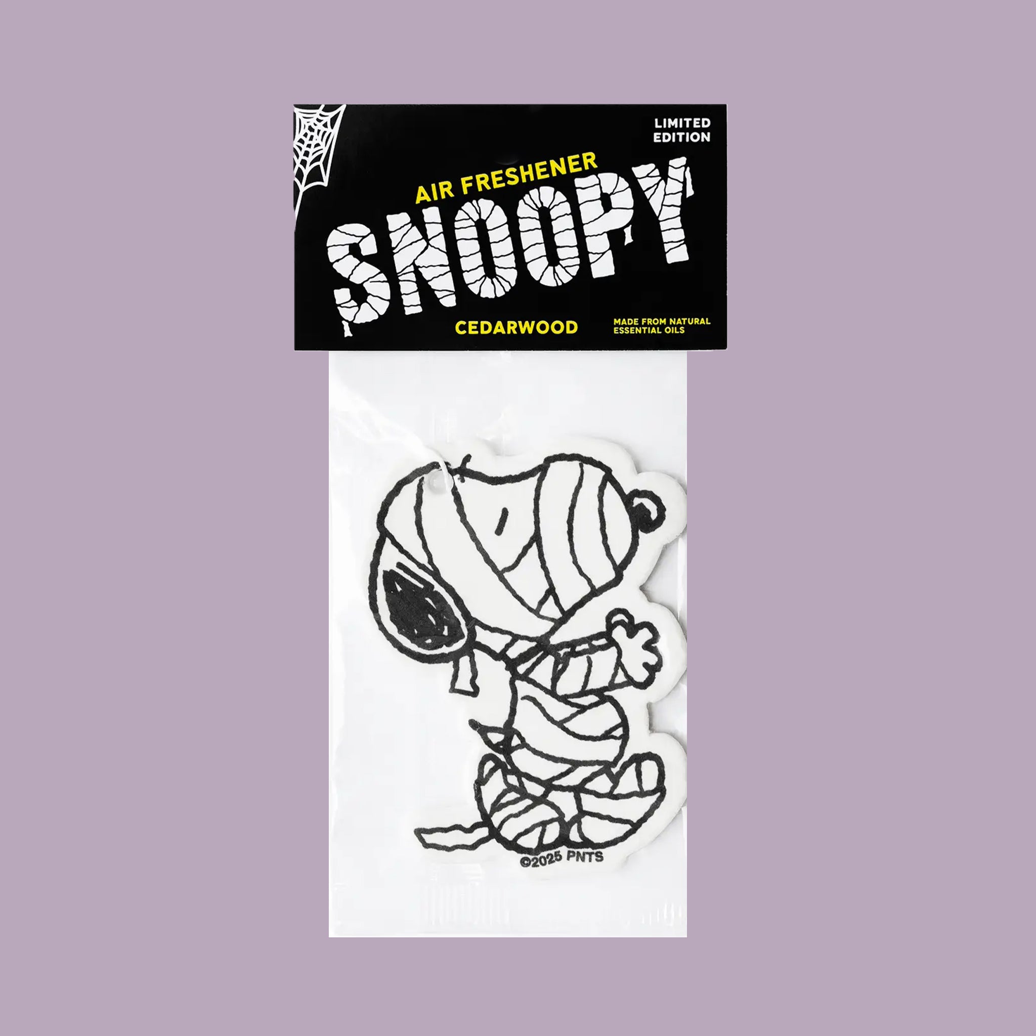 A black and white air freshener shaped liked the iconic Peanuts character Snoopy with text on the packaging that reads, 'Air Freshener Snoopy Cedarwood'. 