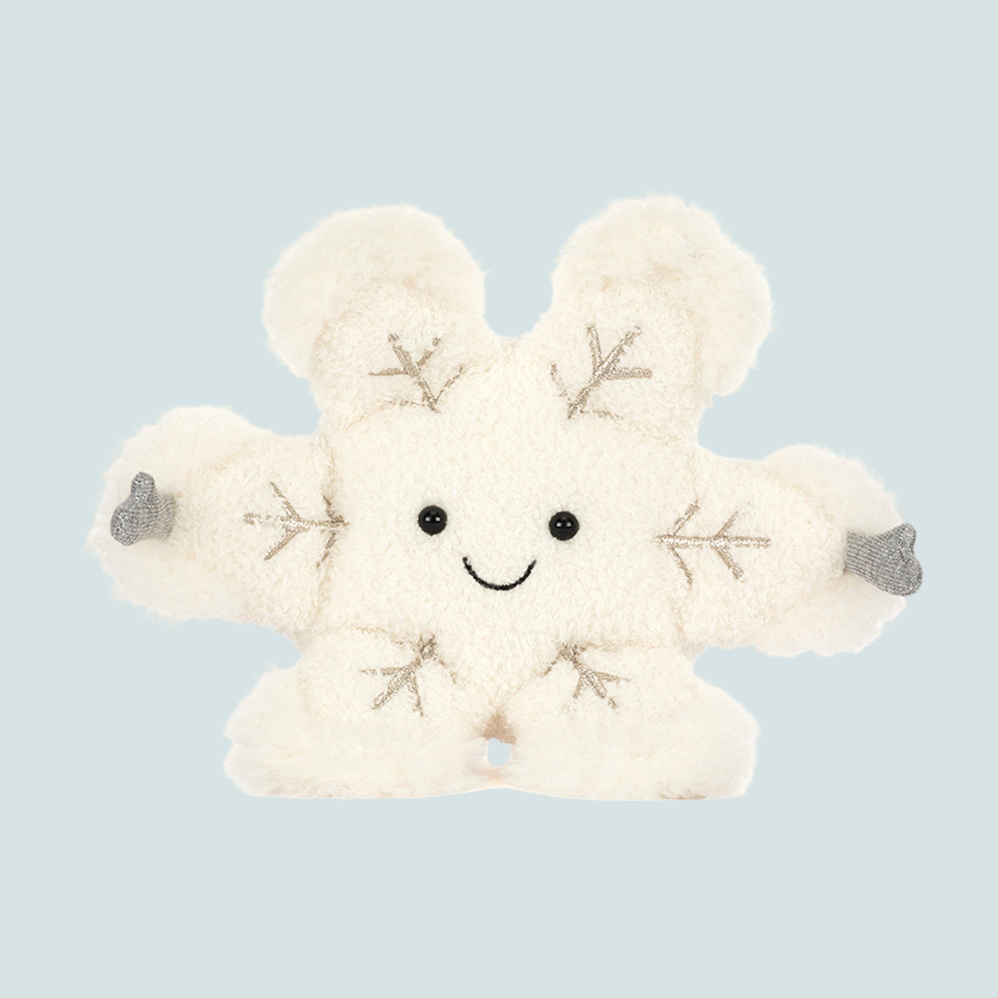 A ivory snowflake shaped stuffed toy with a smiling face in the center and grey mitten covered hands. 
