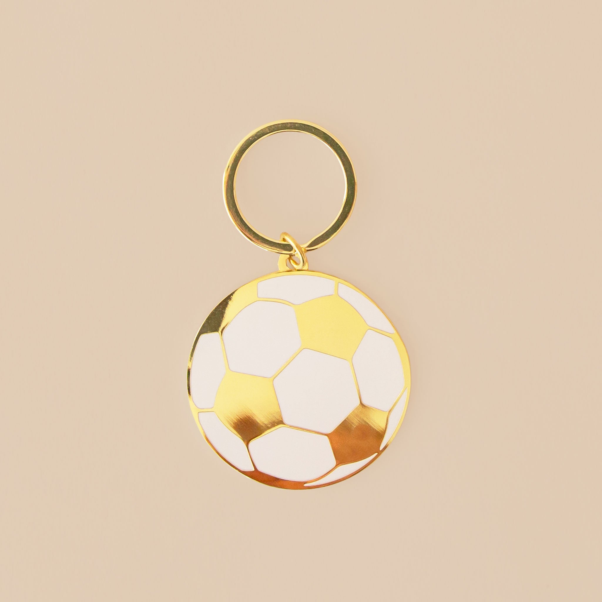 A gold enamel keychain. 
