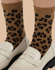 A brown and black pair of leopard print crew socks. 