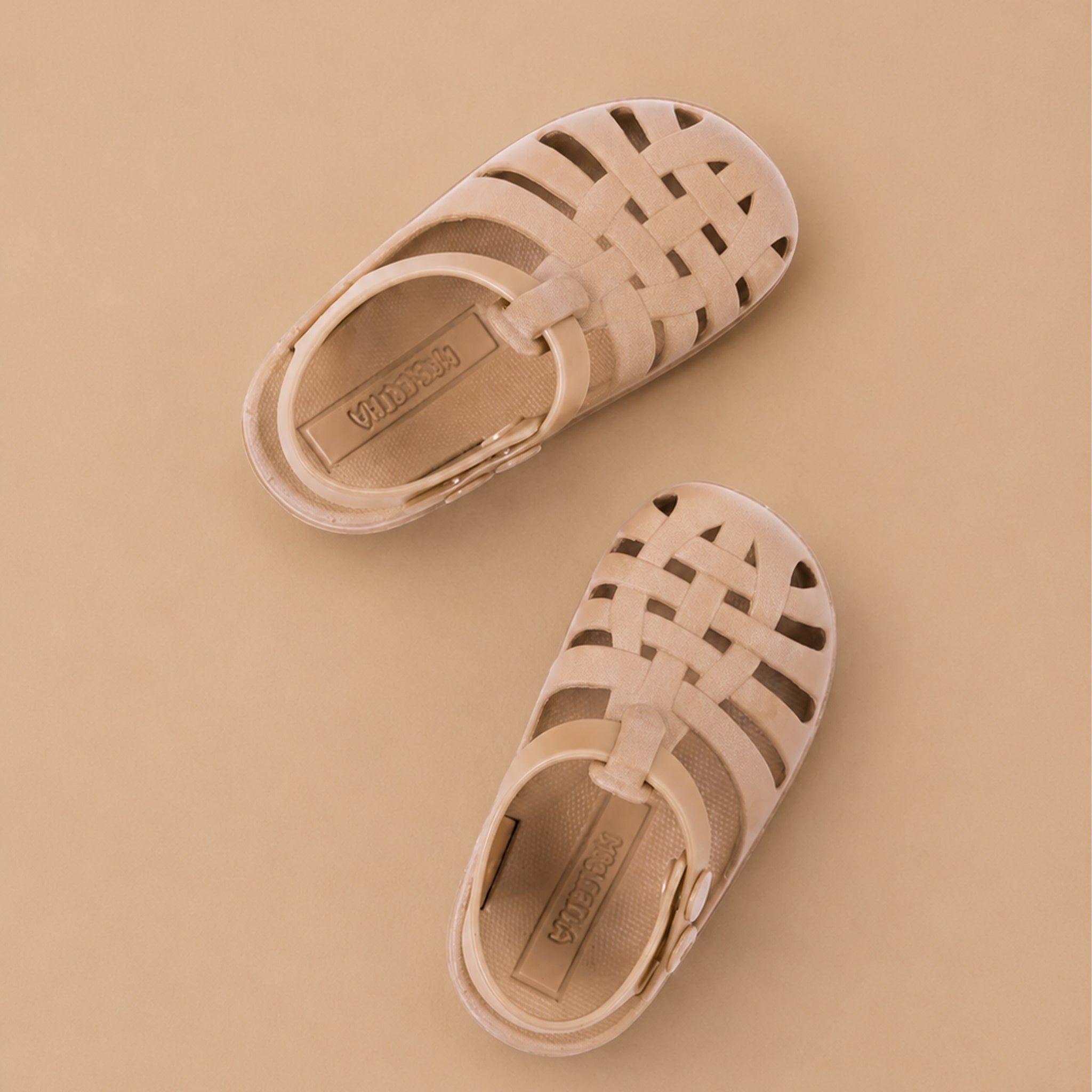 Pair of beige/soft blush sandals on a beige background