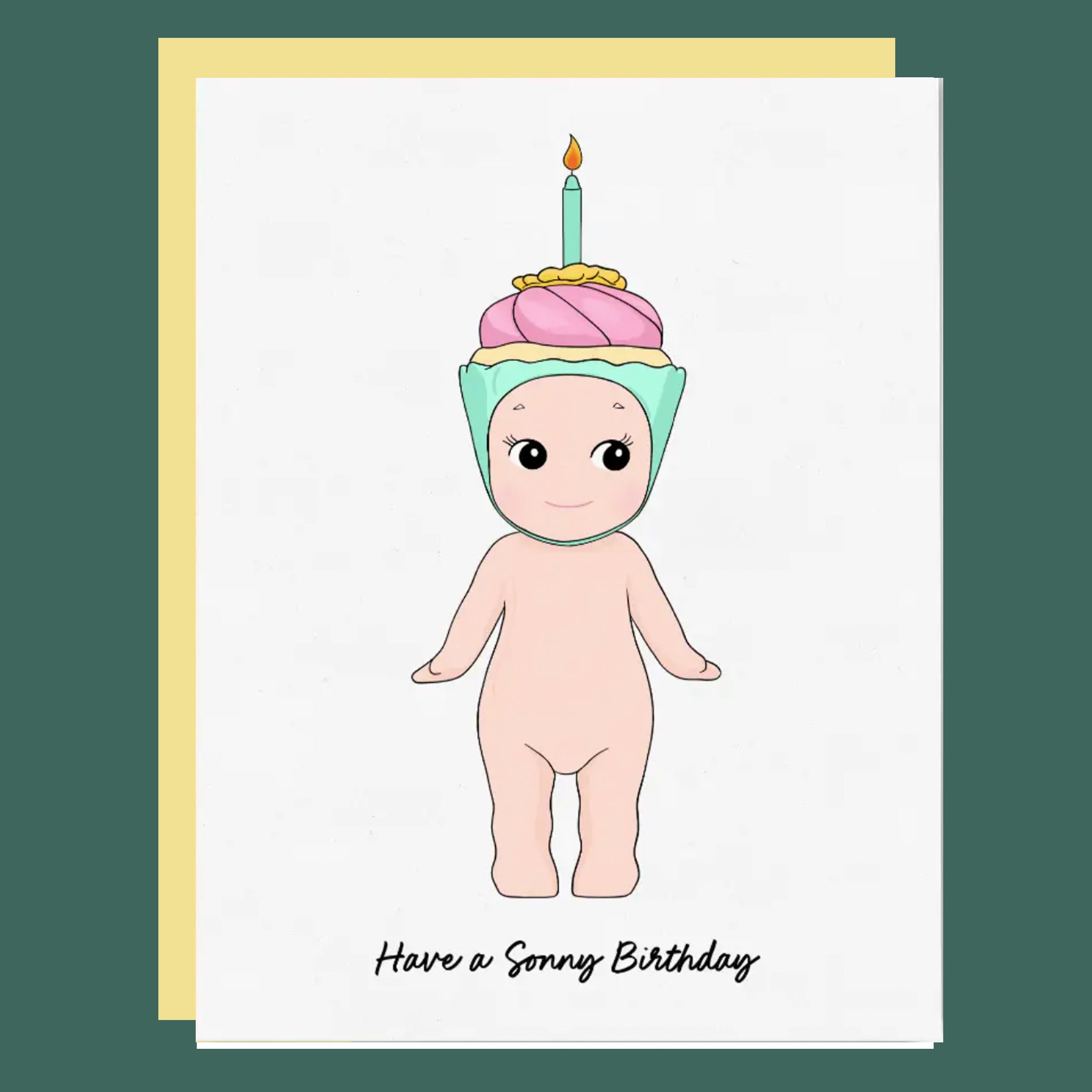 Birthday card with a cartoon character in a cupcake costume and lit candle, on a white background.