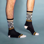 On a blue background is a model wearing a pair of black socks with yellow and white details along with text that reads, "Sounds Like Bullshit To Me".