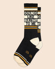 On a neutral background is a pair of black socks with yellow and white details along with text that reads, "Sounds Like Bullshit To Me".