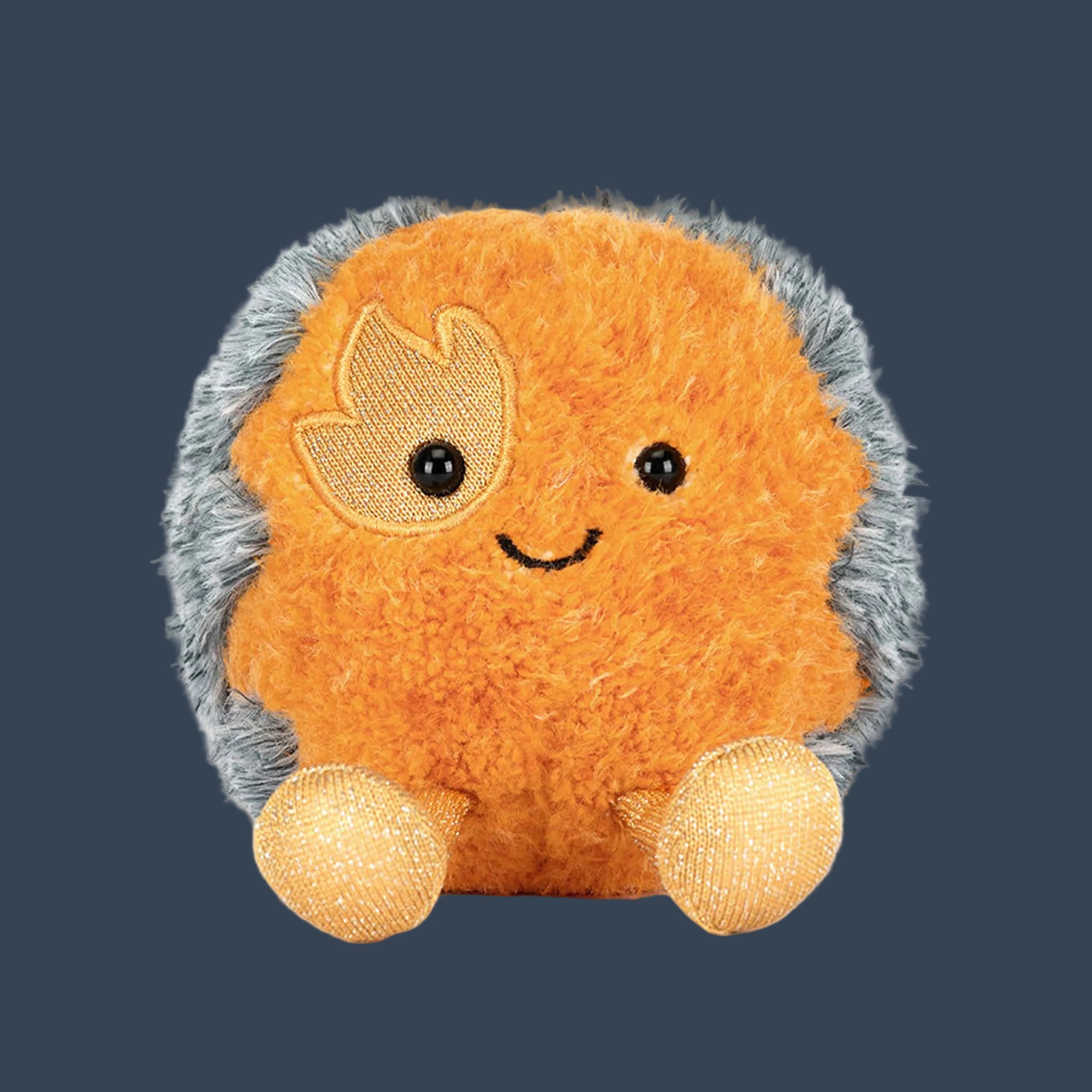 An orange comet shaped stuffed toy. 