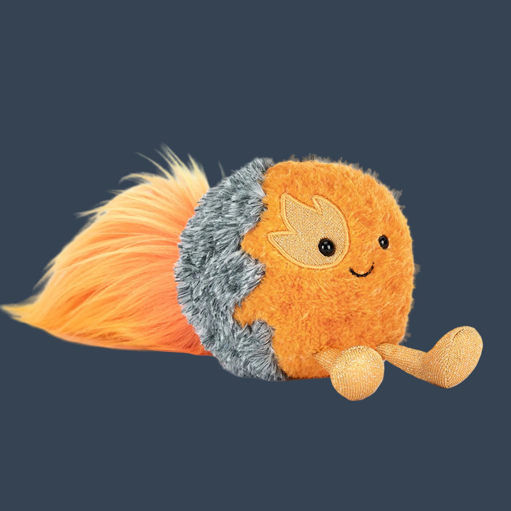 An orange comet shaped stuffed toy. 