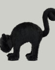 A black cat shaped stuffed animal toy with a spooky arched back. 