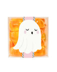 A clear acrylic box of orange and yellow ghost shaped gummy candies. 