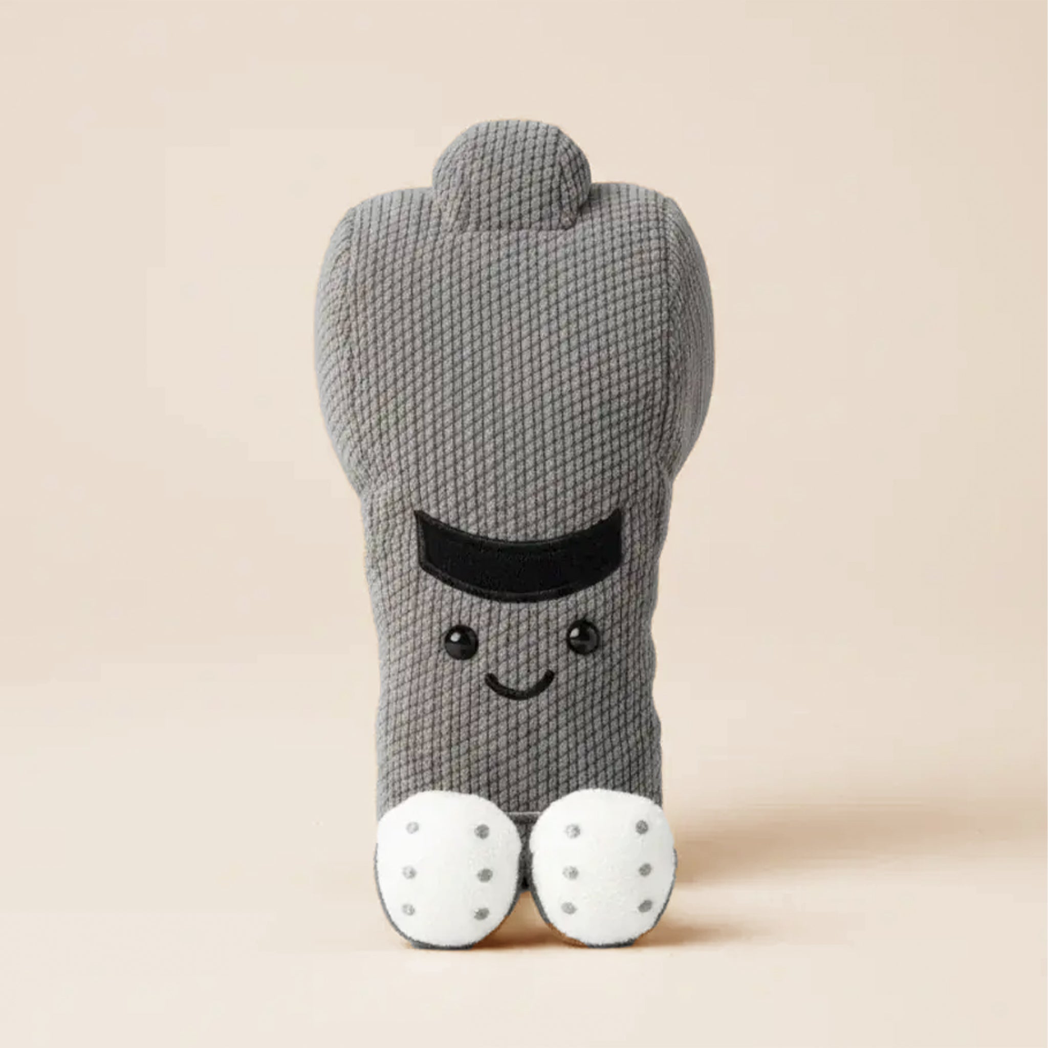 Gray knitted sock with a smiling face on a light gray background