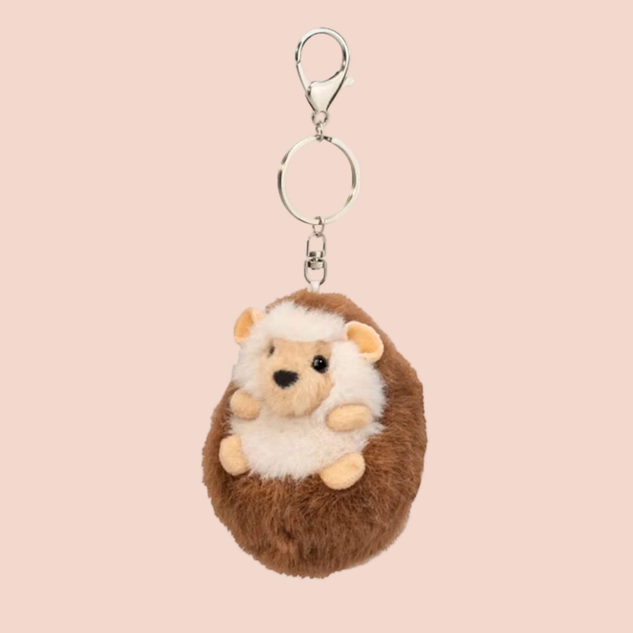 A brown and white hedgehog shaped bag charm keychain. 