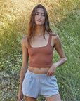 A gingerbread brown colored square neck cropped tank top. 