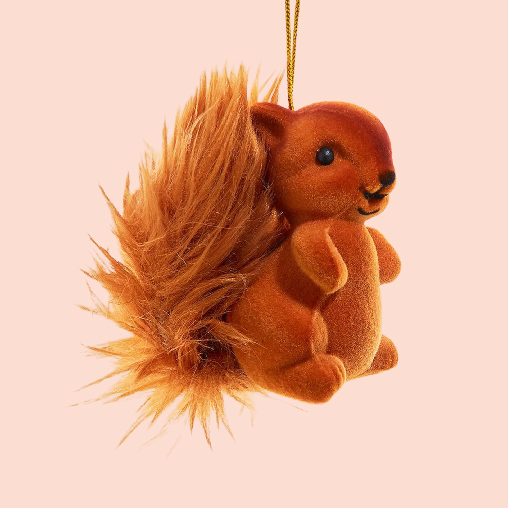 A warm brown flocked squirrel shaped ornament. 