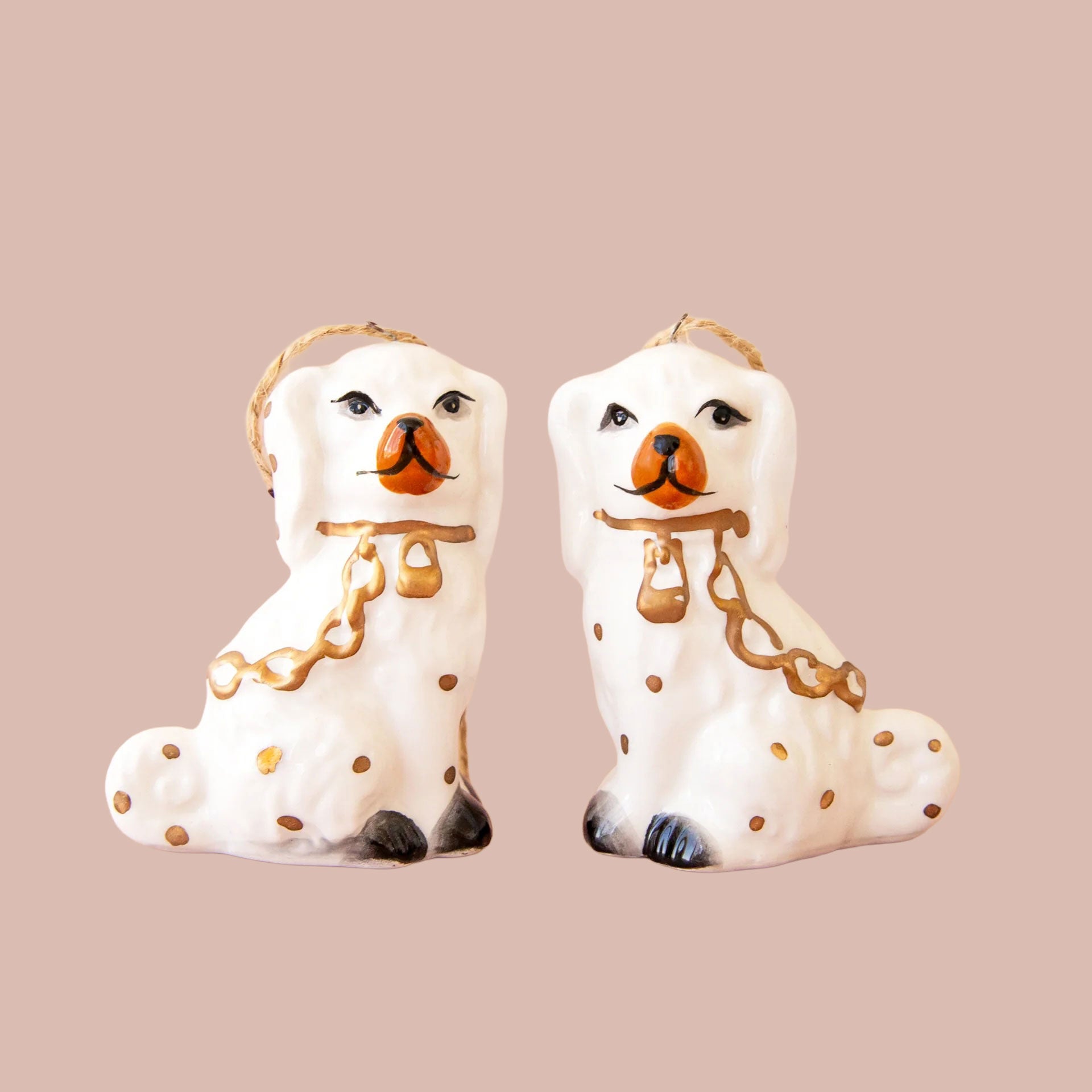 A pair of white dog shaped ornaments. 