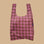 A pink and light green plaid nylon tote bag.