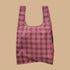 A pink and light green plaid nylon tote bag.