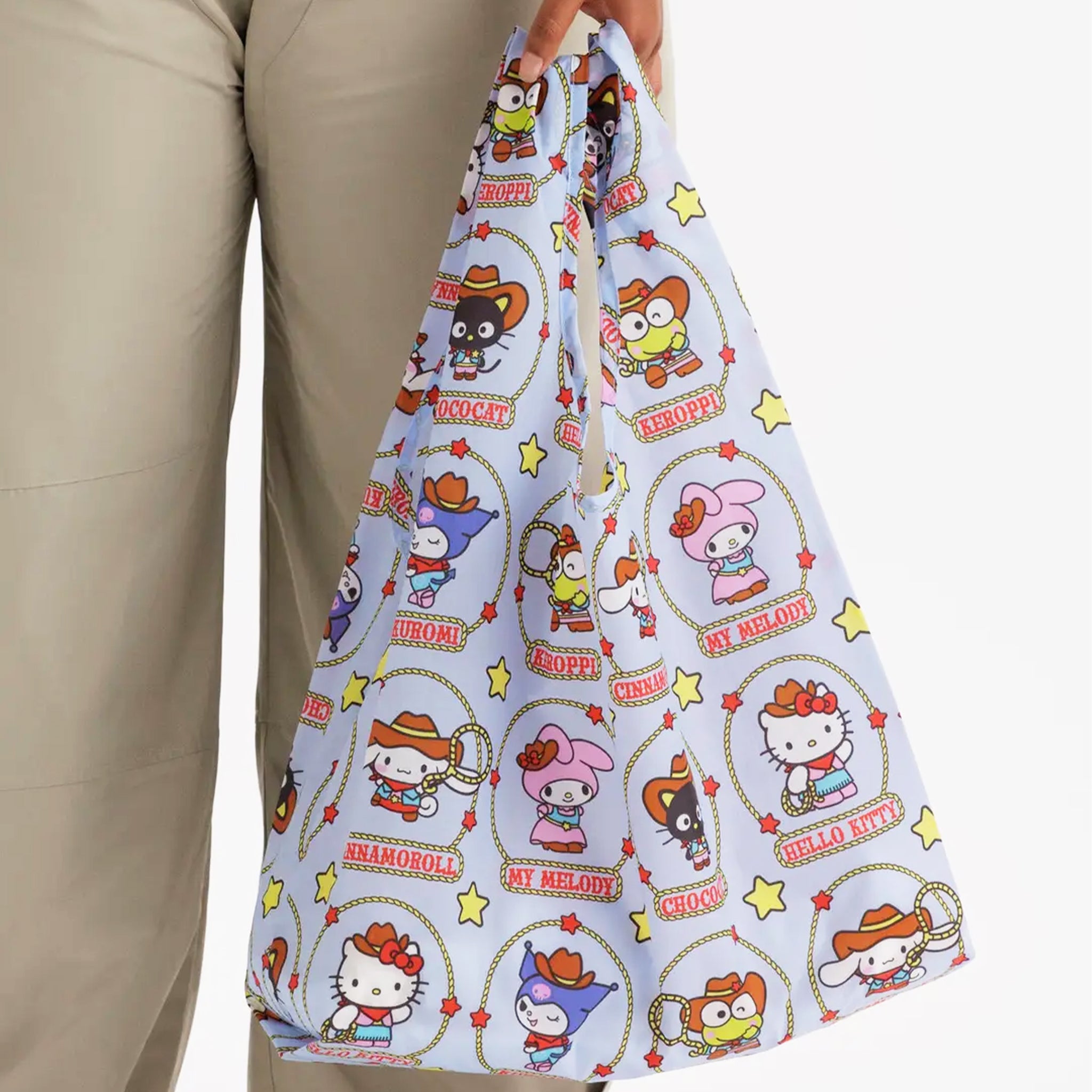 A nylon tote bag with a hello kitty and friends western pattern. 